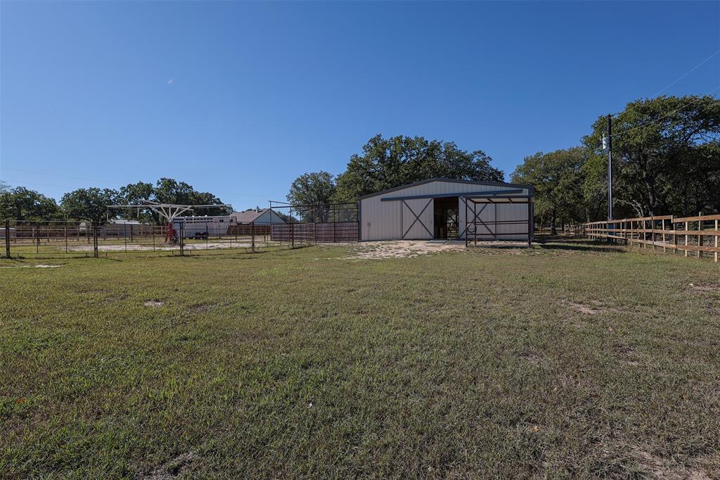 111 Deerfield Road Paradise, TX 76073 - Photo 29 of 39 View of yard featuring an outbuilding and an outdoor structure