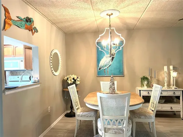 a dining room with a window and chairs