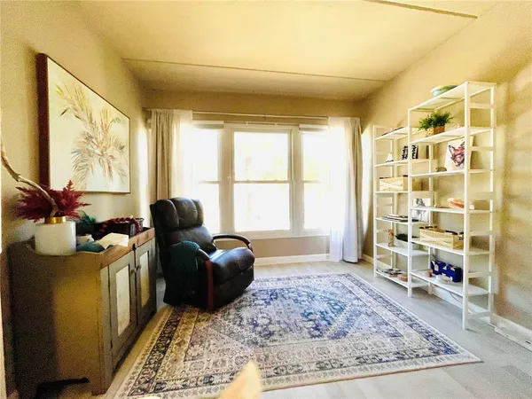 a living room with furniture rug and window