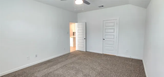 an empty room with closet area