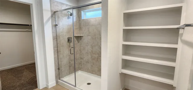 a bathroom with a glass shower door