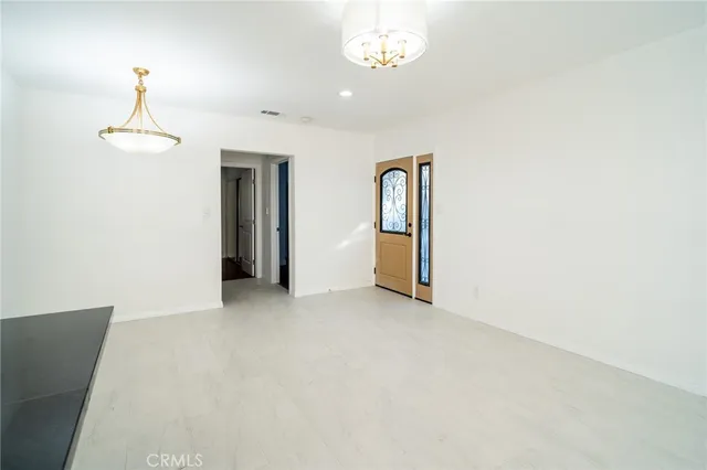 a view of an empty room with a chandelier