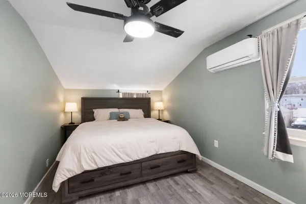 a bedroom with a bed and a chandelier
