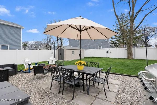 a view of an outdoor sitting area with furniture and backyard
