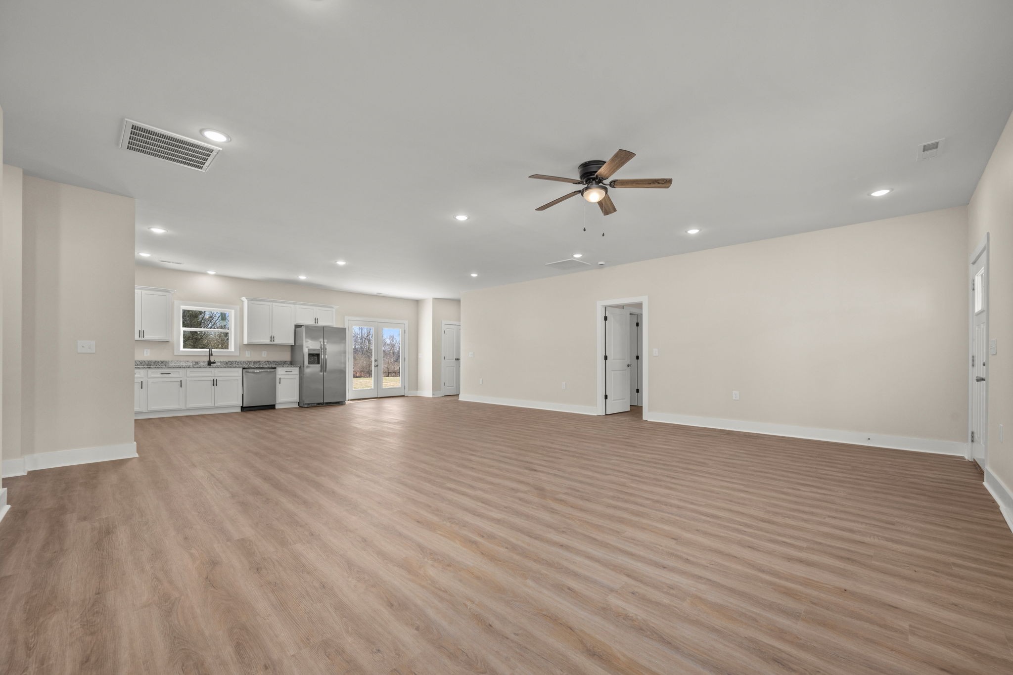 254 Flintville Road Flintville, TN 37335 - Photo 15 of 38 a view of empty room with wooden floor and ceiling fan