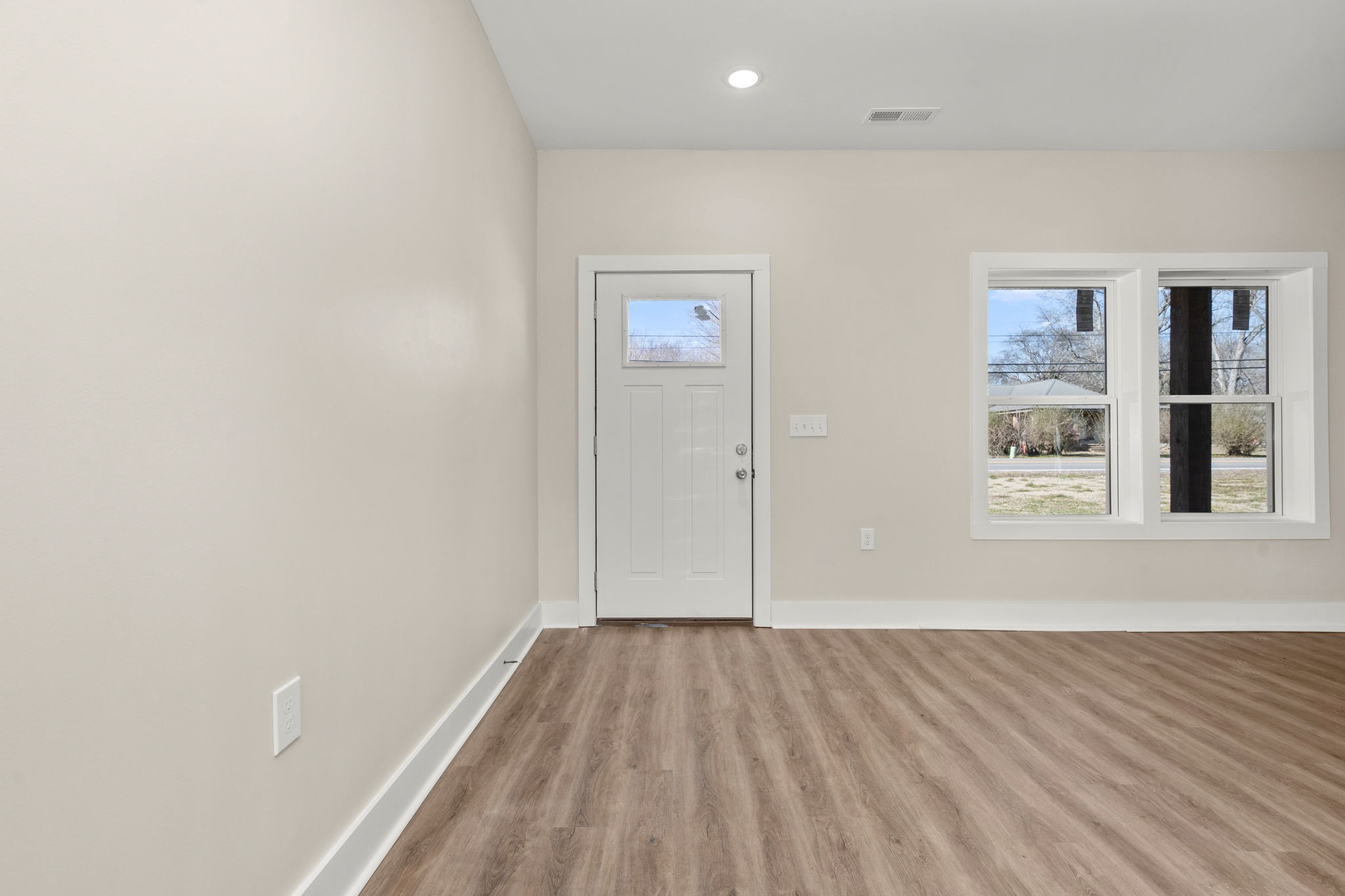 254 Flintville Road Flintville, TN 37335 - Photo 17 of 38 an empty room with wooden floor and windows