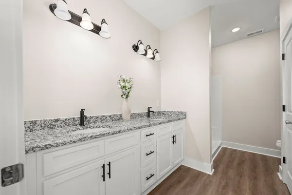 a bathroom with a granite countertop sink and a mirror