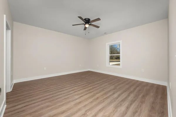 wooden floor in an empty room with a window