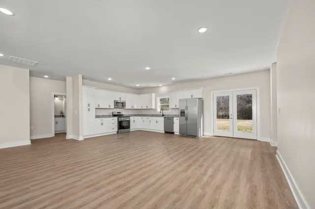a view of a kitchen with wooden floor