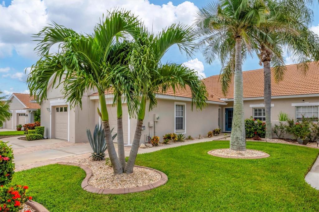 640 Back 9 Drive Venice, FL 34285 - Photo 2 of 54 a view of a house with a yard and palm trees