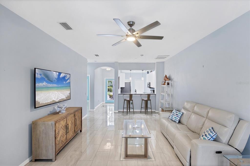 640 Back 9 Drive Venice, FL 34285 - Photo 21 of 54 a living room with furniture and a flat screen tv