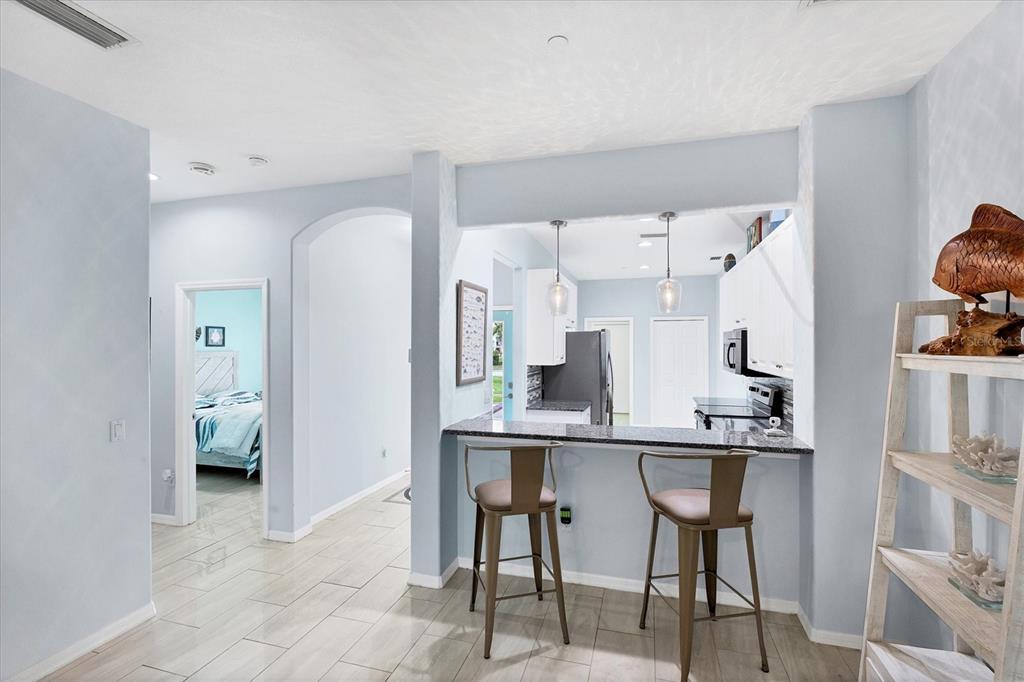 640 Back 9 Drive Venice, FL 34285 - Photo 25 of 54 a kitchen with stainless steel appliances a table and chairs in it