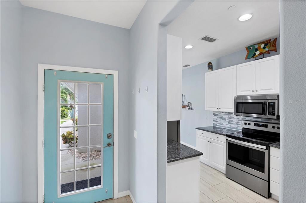 640 Back 9 Drive Venice, FL 34285 - Photo 27 of 54 a kitchen with stainless steel appliances and stove top oven