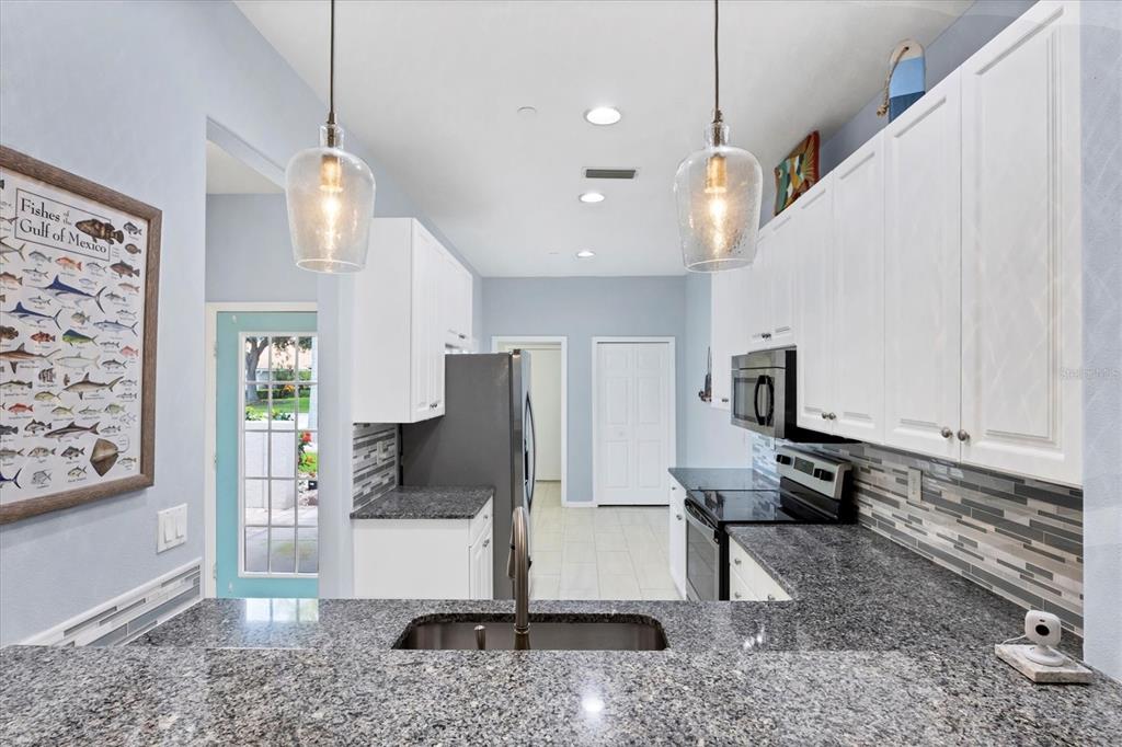 640 Back 9 Drive Venice, FL 34285 - Photo 28 of 54 a view of a living room and kitchen with stainless steel appliances