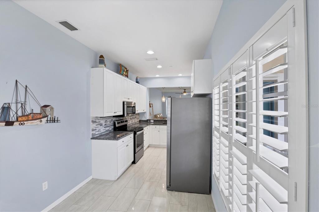 640 Back 9 Drive Venice, FL 34285 - Photo 33 of 54 a kitchen with stainless steel appliances a refrigerator and a stove top oven