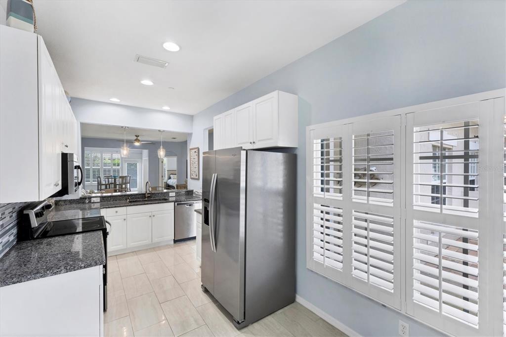 640 Back 9 Drive Venice, FL 34285 - Photo 34 of 54 a kitchen with refrigerator and cabinets