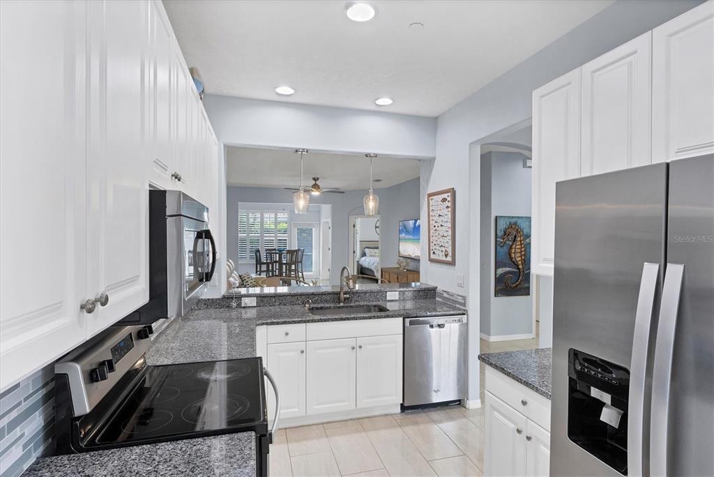640 Back 9 Drive Venice, FL 34285 - Photo 35 of 54 a kitchen with stainless steel appliances granite countertop a refrigerator a stove and a sink