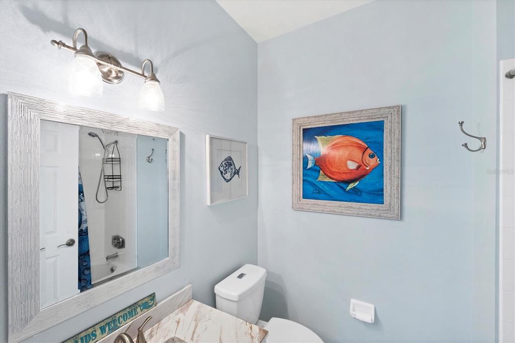 640 Back 9 Drive Venice, FL 34285 - Photo 52 of 54 a bathroom with a toilet a sink and mirror