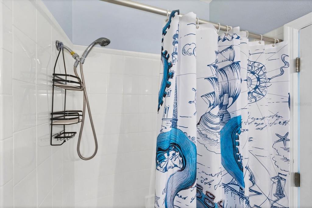 640 Back 9 Drive Venice, FL 34285 - Photo 53 of 54 a bathroom with a bathtub and shower curtain