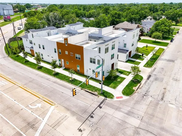 a view of a house with a yard and potted plants