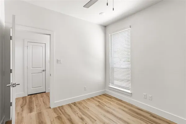 a bathroom with a granite countertop sink toilet mirror and bathtub