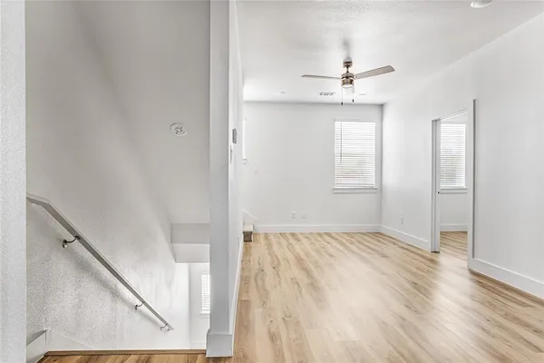 a view of an empty room with wooden floor