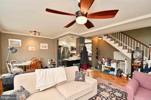 a living room with furniture and a chandelier
