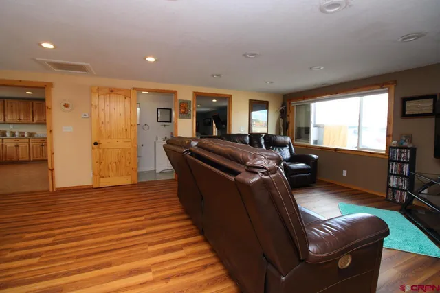 a living room with furniture window and wooden floor
