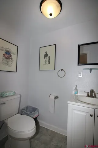 a bathroom with a toilet a sink and mirror