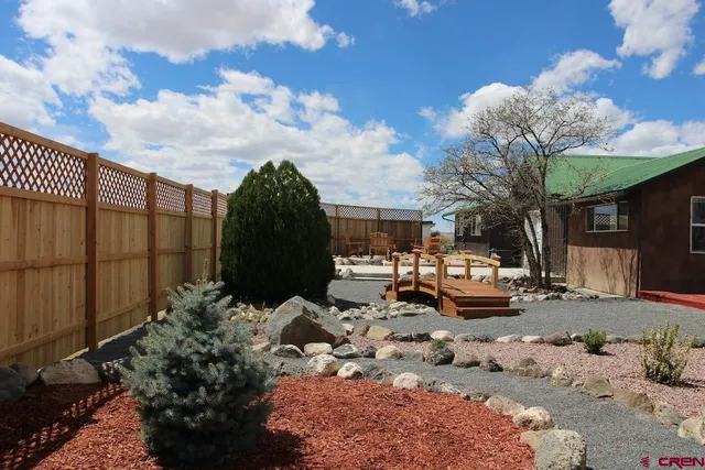 a backyard of a house with fire pit and outdoor seating