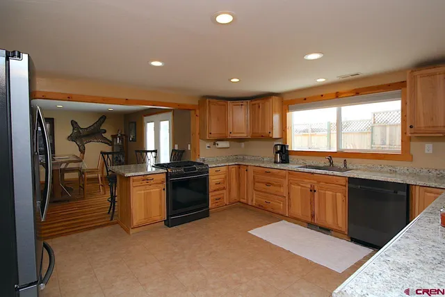 a large kitchen with lots of counter space and sink