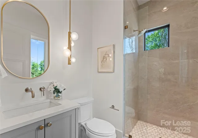 a bathroom with a sink vanity granite and toilet