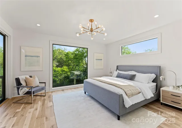 a bedroom with a bed chairs and a window