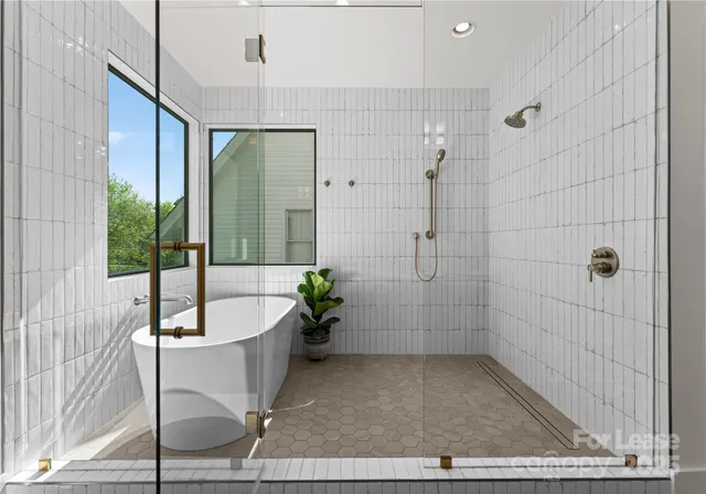 a bathroom with a tub a shower and a sink