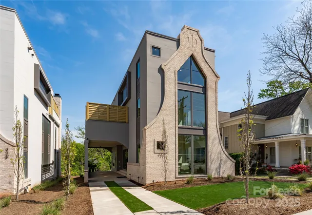 a view of a white house next to a yard