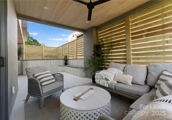 a view of a livingroom with furniture and a large window