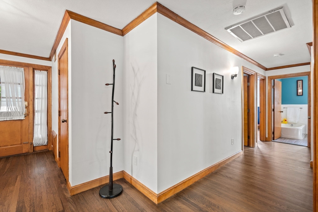 58 Spring Street Wakefield, MA 01880 - Photo 17 of 41 a view of a hallway with wooden floor and entryway