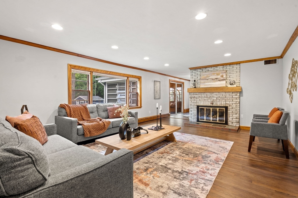 58 Spring Street Wakefield, MA 01880 - Photo 2 of 41 a living room with furniture and a fireplace