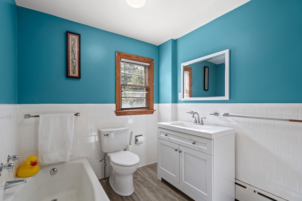 58 Spring Street Wakefield, MA 01880 - Photo 23 of 41 a bathroom with a sink a toilet and mirror