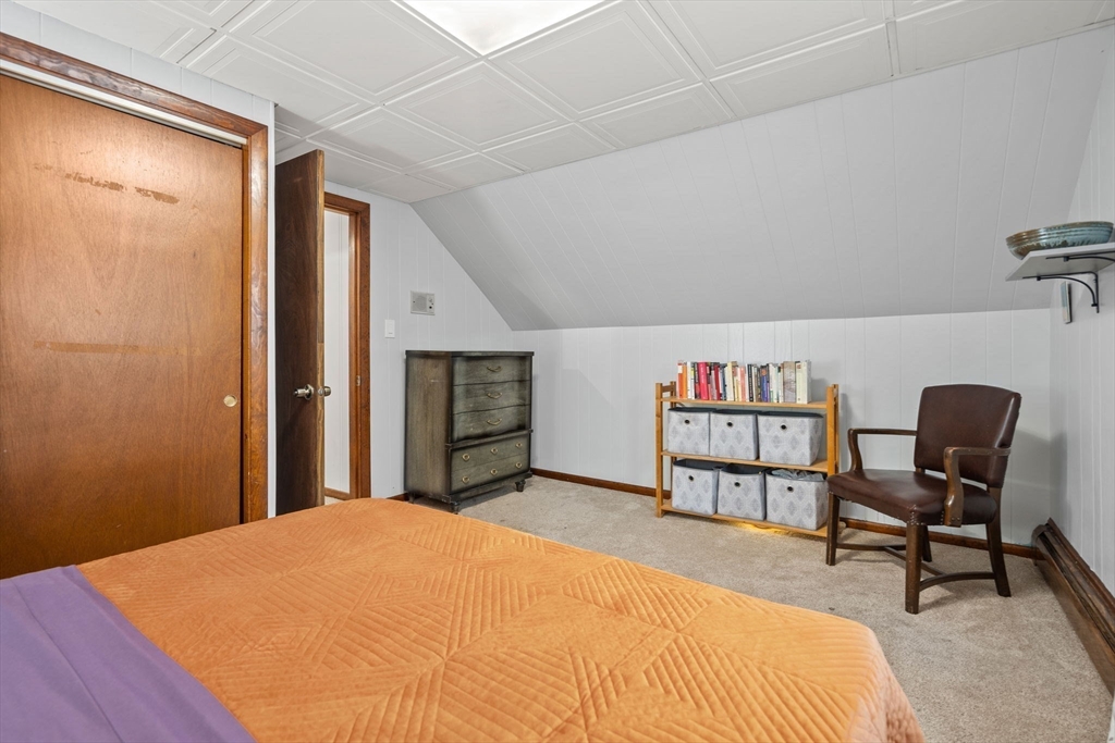 58 Spring Street Wakefield, MA 01880 - Photo 27 of 41 a bedroom with a bed a table and bookshelf