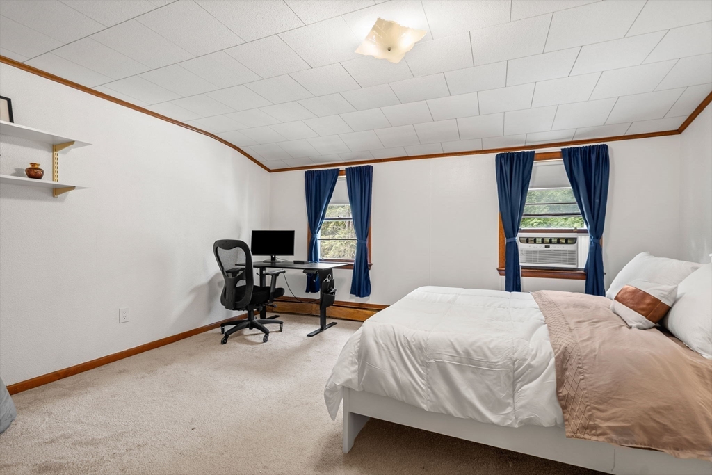 58 Spring Street Wakefield, MA 01880 - Photo 28 of 41 a bedroom with a bed chair and a large window