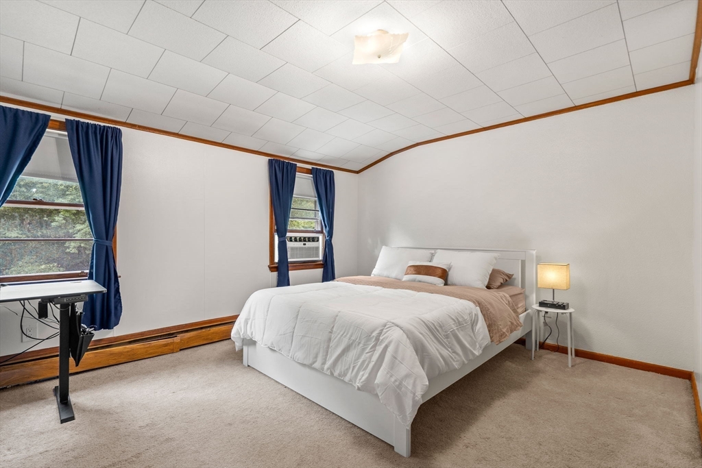 58 Spring Street Wakefield, MA 01880 - Photo 29 of 41 a bedroom with a bed and a window