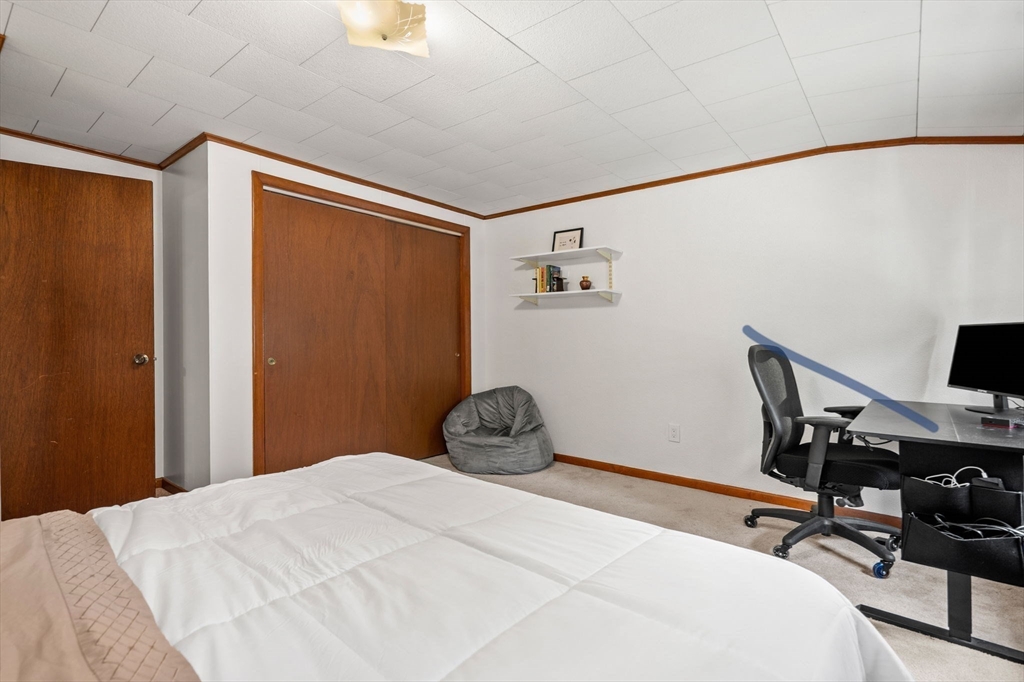 58 Spring Street Wakefield, MA 01880 - Photo 30 of 41 a bedroom with a bed and a computer on a table