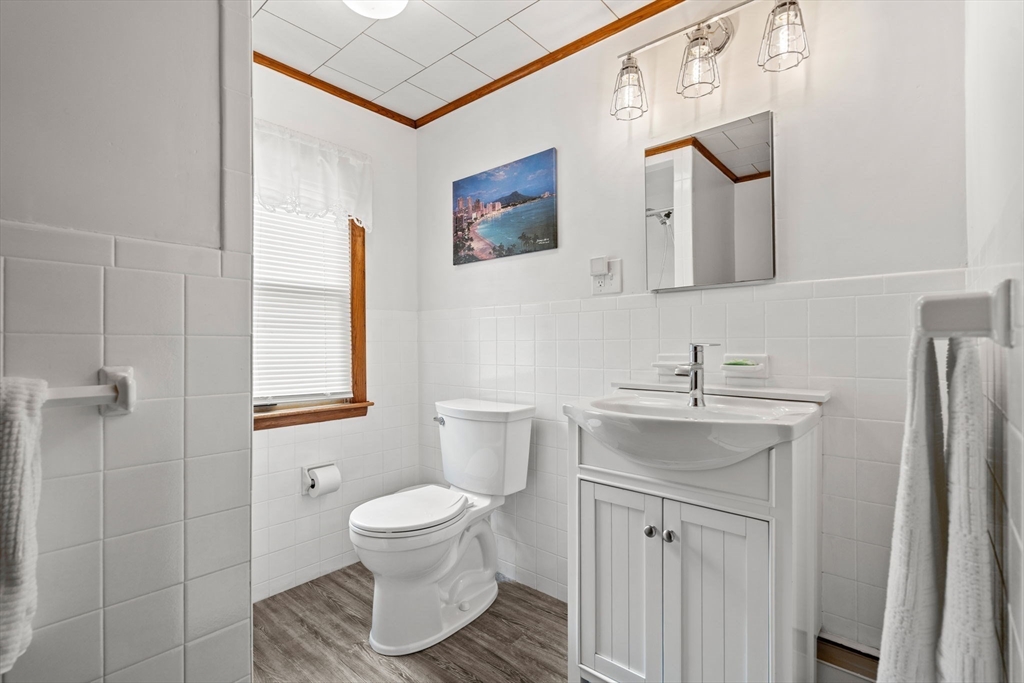 58 Spring Street Wakefield, MA 01880 - Photo 31 of 41 a bathroom with a toilet sink and mirror