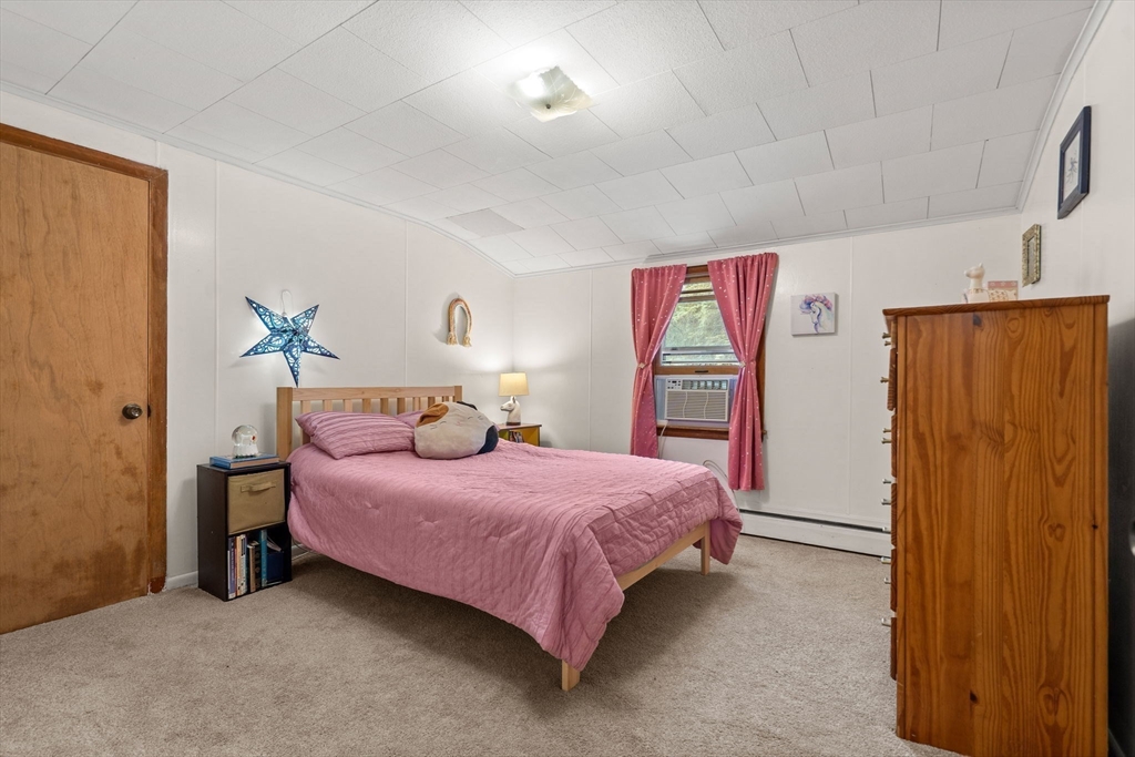 58 Spring Street Wakefield, MA 01880 - Photo 32 of 41 a bedroom with a bed and a table