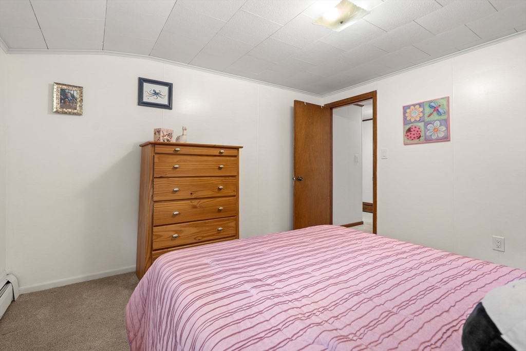 58 Spring Street Wakefield, MA 01880 - Photo 33 of 41 a bedroom with a bed and a dresser