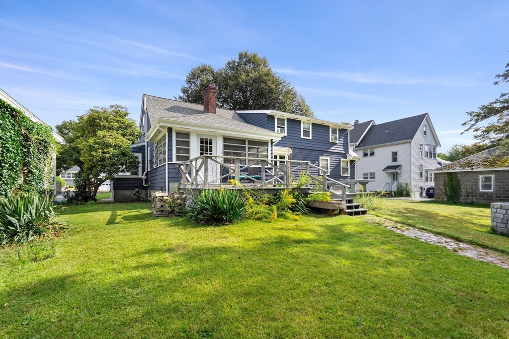 58 Spring Street Wakefield, MA 01880 - Photo 37 of 41 a view of a house with a yard porch and sitting area