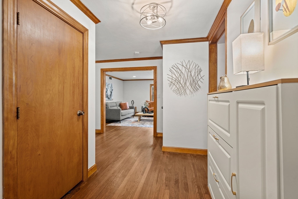58 Spring Street Wakefield, MA 01880 - Photo 7 of 41 a view of a hallway with wooden floor and staircase