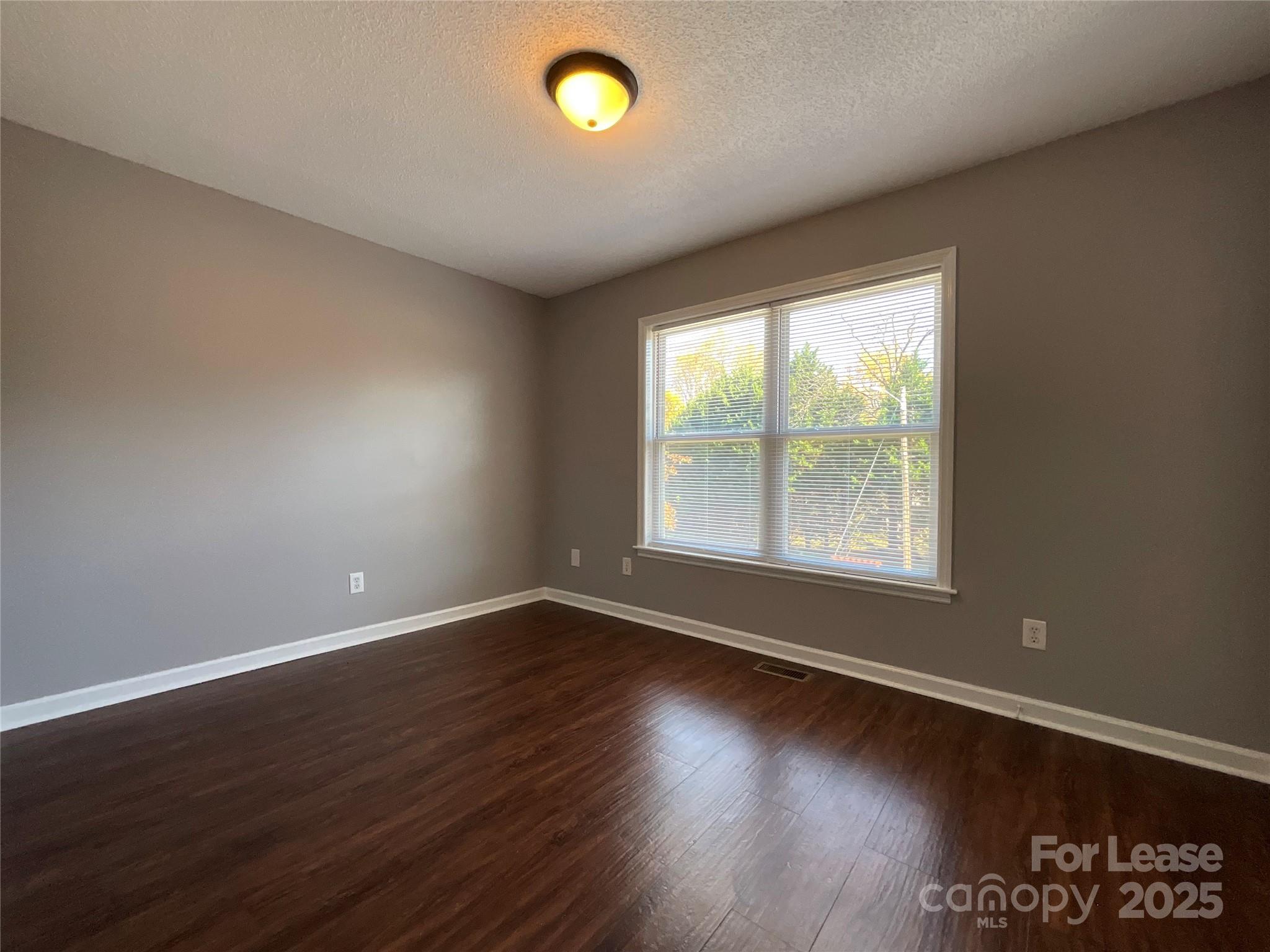 206 West 15th Street, Unit 2 Newton, NC 28658 - Photo 11 of 14 an empty room with wooden floor and windows