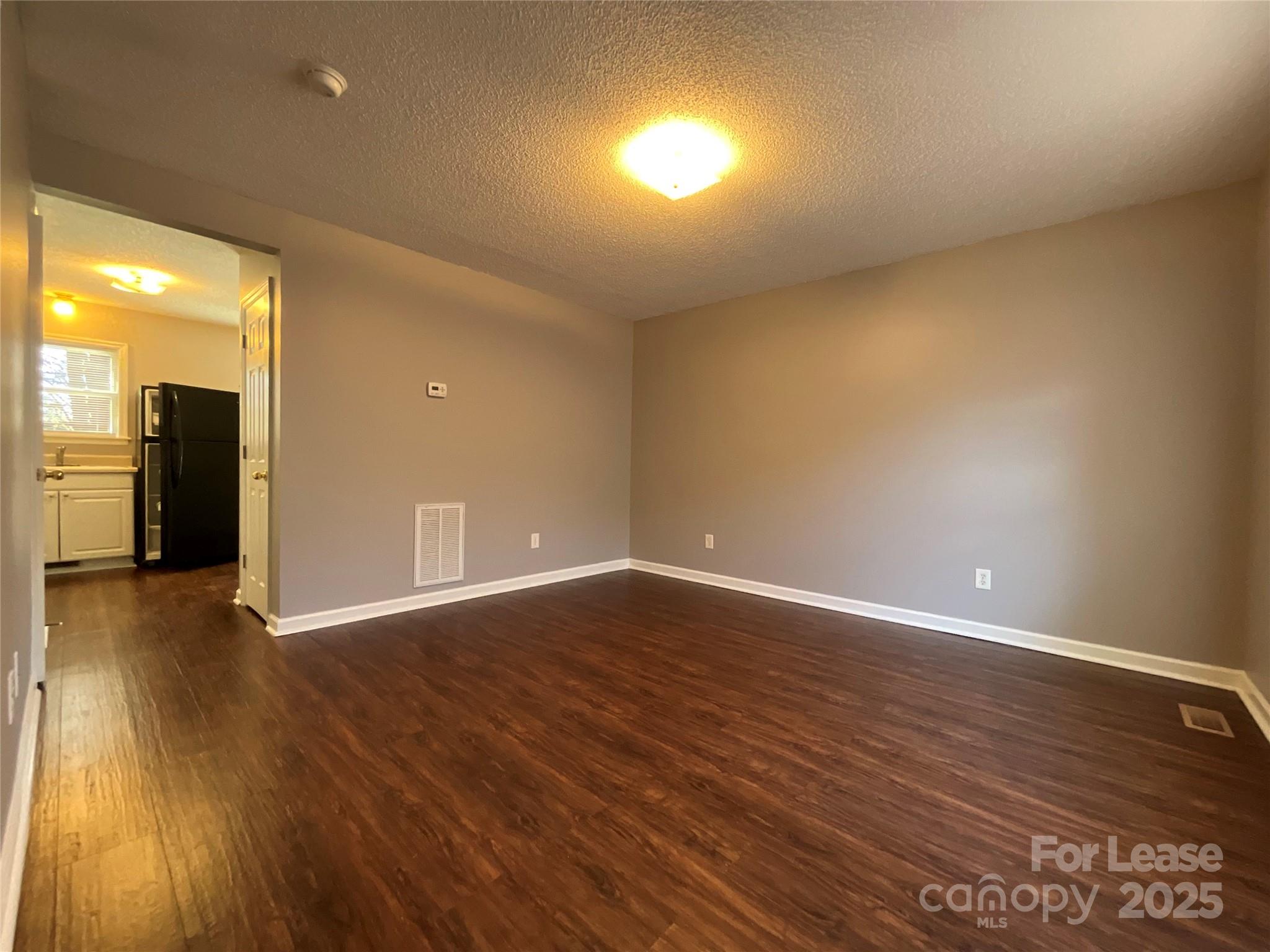 206 West 15th Street, Unit 2 Newton, NC 28658 - Photo 2 of 14 an empty room with wooden floor and windows